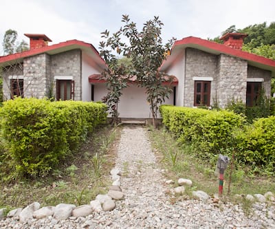 https://imgcld.yatra.com/ytimages/image/upload/t_hotel_yatra_city_desktop/v1390499349/Domestic Hotels/Hotels_Corbett/Hotel Corbett Roop Resort/Cottage5.jpg